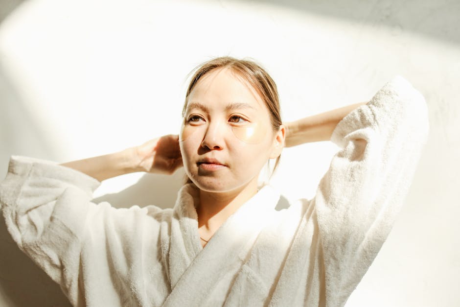 woman touching forehead skincare anti-aging routine natural light landscape