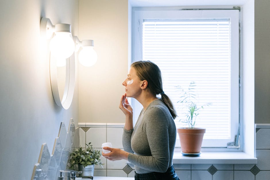 woman applying serum face morning bathroom routine
