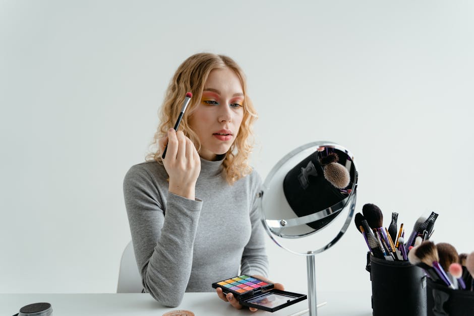 Peau brillante : 8 astuces express pour mater le sébum et retrouver un teint mat woman applying matifying powder compact mirror handbag beauty touch up