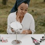 woman with sensitive skin applying gentle skincare cream natural light landscape