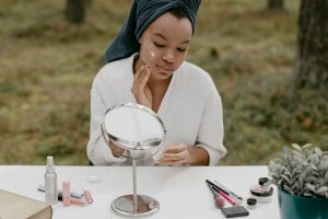 woman with sensitive skin applying gentle skincare cream natural light landscape