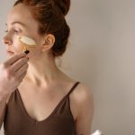 woman facial massage glowing skin natural light beauty routine landscape
