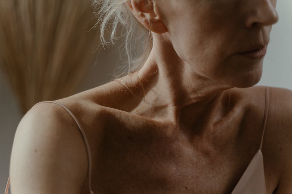 woman looking down at smartphone neck wrinkles natural light