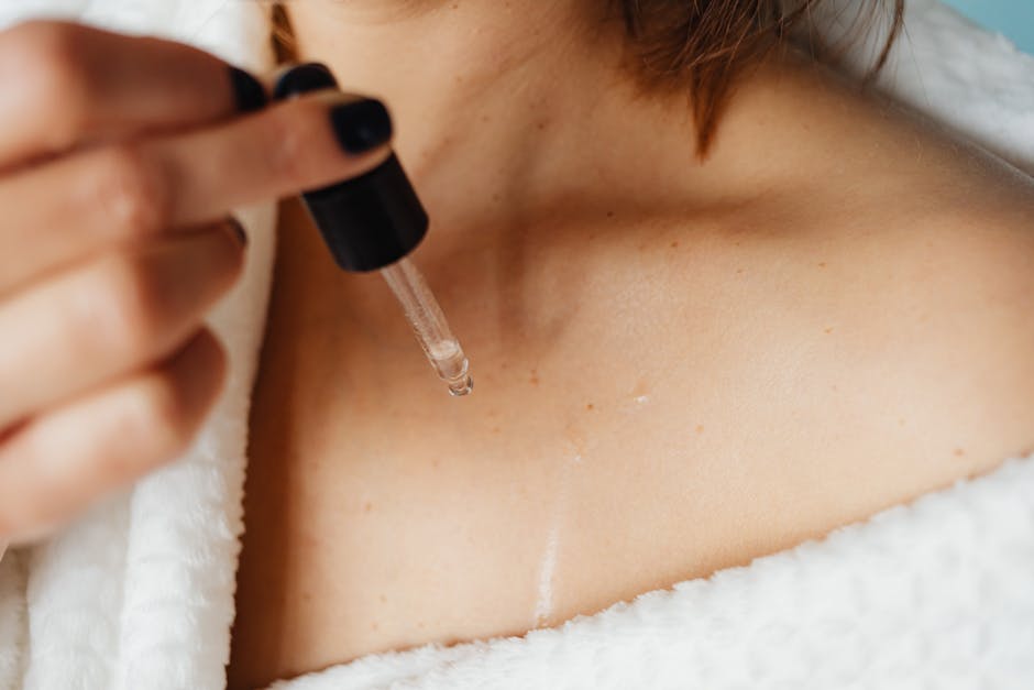 woman applying facial oil on dry skin close-up