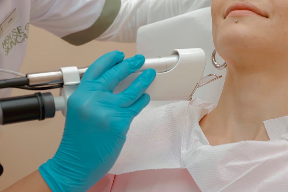 dermatologist using skin analysis device woman face