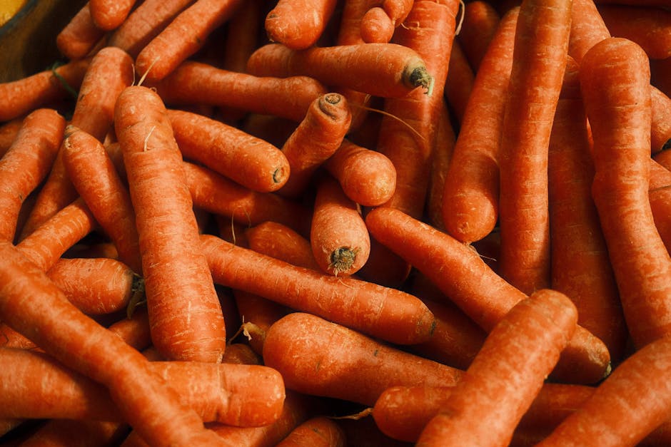 Les 5 vitamines anti-âge essentielles pour une peau jeune et lumineuse fresh carrots orange vegetables bright background