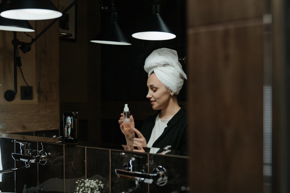 woman using cleansing wipe skincare routine bathroom mirror landscape