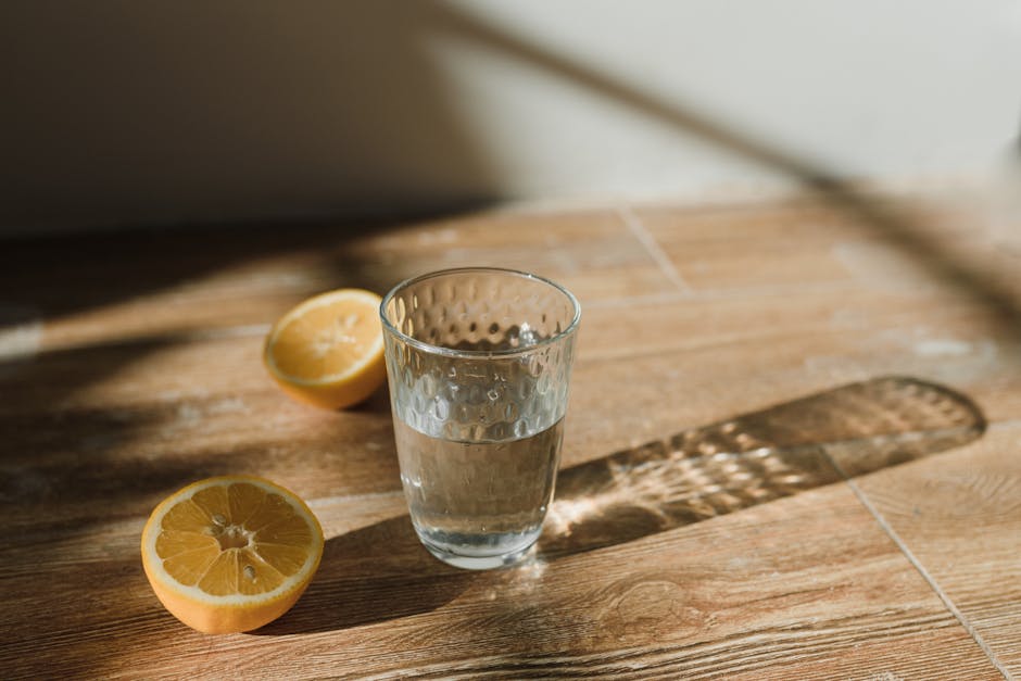 glass of water lemon slices fresh vegetables hydration concept