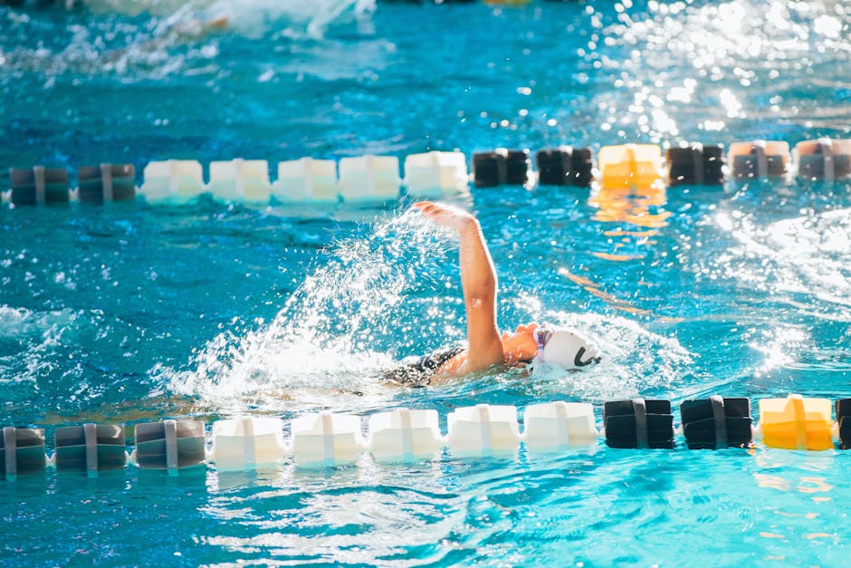 woman swimming backstroke in a pool athletic silhouette