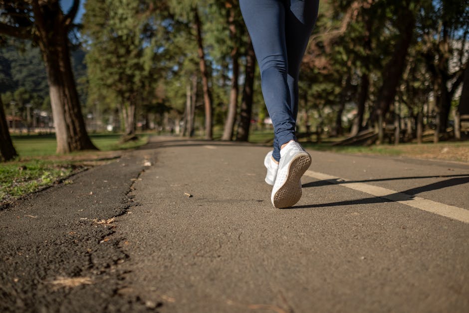 woman running outdoors on a park path in athletic wear