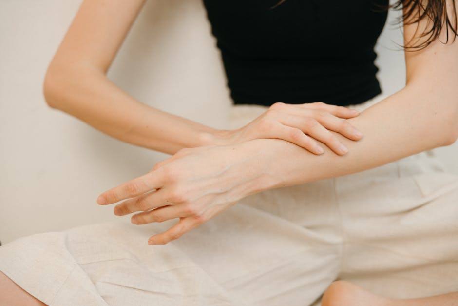 woman applying self-tanner arms natural glow skincare