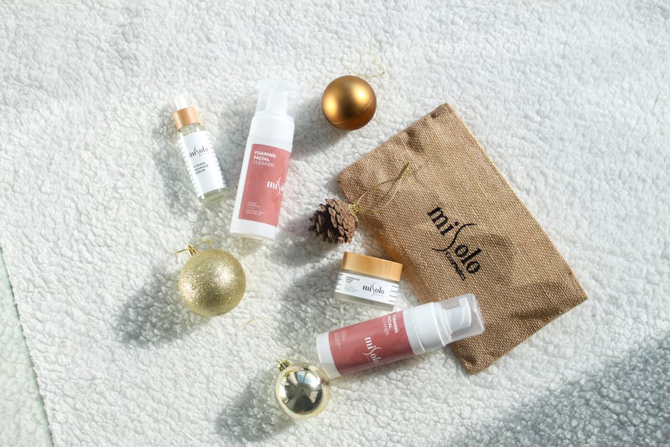 skincare products flatlay with serum moisturizer and cleanser on marble surface