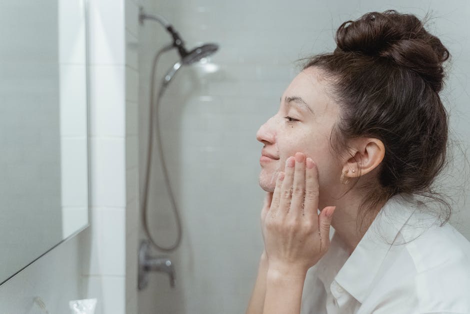 woman fresh glowing skin morning skincare routine bathroom mirror landscape