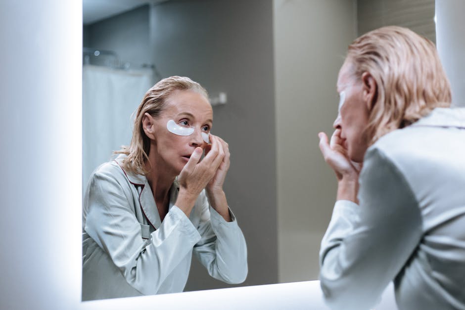 woman looking in mirror touching cheeks anti-aging skincare