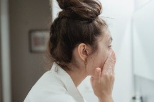 woman mixed skin face beauty routine skincare products natural light