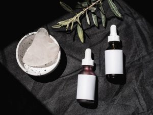 collection of natural plant oils glass bottles beauty skincare flat lay