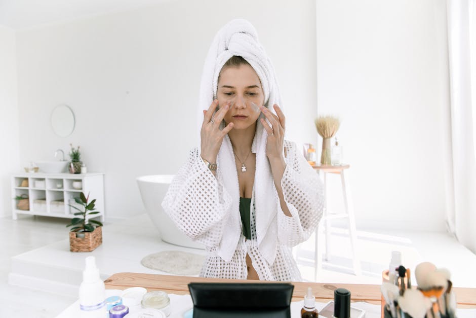 woman applying facial oil drops skin bright bathroom