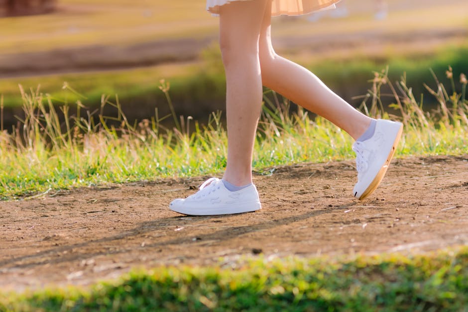 close up female legs walking path nature